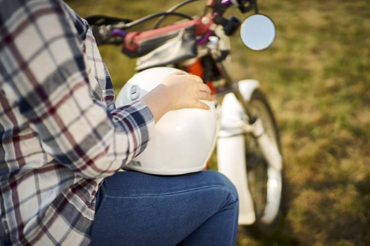 バイクに腰を掛ける人