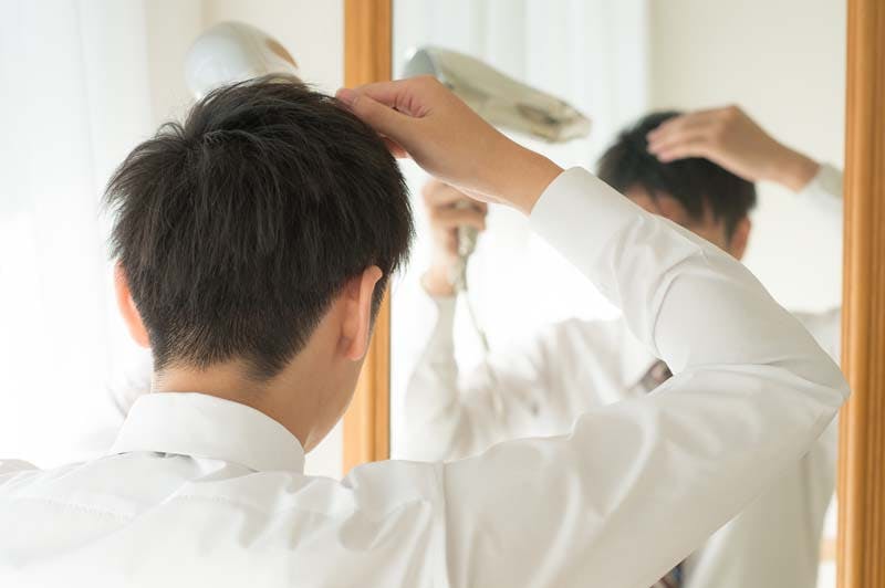 髪の毛のセットをする男性画像