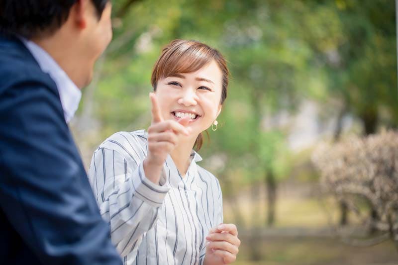 男性に向かって冗談を言う女性のイメージ画像